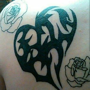 I drew this, my mother loves heart designs so i mashe a couple different tribal designs together. Mason started this piece for me. #tribaltattoos #heart #roses 