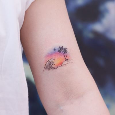Sunset over the island. Tattoo by Saegeemtattoo #saegeemtattoo #tropicaltattoos #color #watercolor #linework #fineline #small #palmtree #island #waves #ocean #sea #moon #sunset #landscape #seascape
