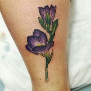 Beautiful flower tattoo on lower leg, designed by talented artist Sean Ross Fawkes. Enjoy a unique and artistic piece of body art