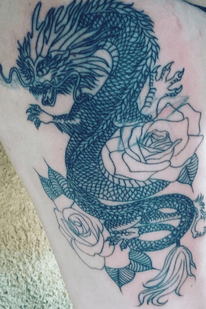 Start of an oriental dragon on thigh not sure to do color or keep it black and grey (note; it covers a failure of another tattoo)