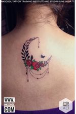 Delicate floral dream catcher tattoo in the shape of a crescent moon, designed and tattooed by Tattoo Artist Syed Hamza Ali at INKSCOOL Tattoo Training Institute And Studio Pune India ™