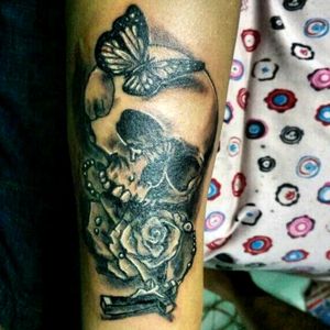 Black and grey tattooSkull with rose and butterfly