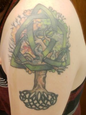 Celtic Knot with a modified  Tree of Life. Tree top is the seasons signifying from birth to death. Got this in honor of the daughter I lost Illiana. Her name is "carved" into the trunk. Work done by Isaac Velasco
