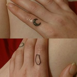 Coffin and moon finger tattoos.