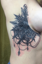 Ornamental side boob tattoo