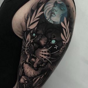 Tattoo by Cristian Casas #CristianCasas #tattoodoambassador #neotraditional #blackandgrey #Lion #whiteink #blueink #junglecat #cat #fangs #pearls #leaves #nature #animal #lady #ladyhead #portrait