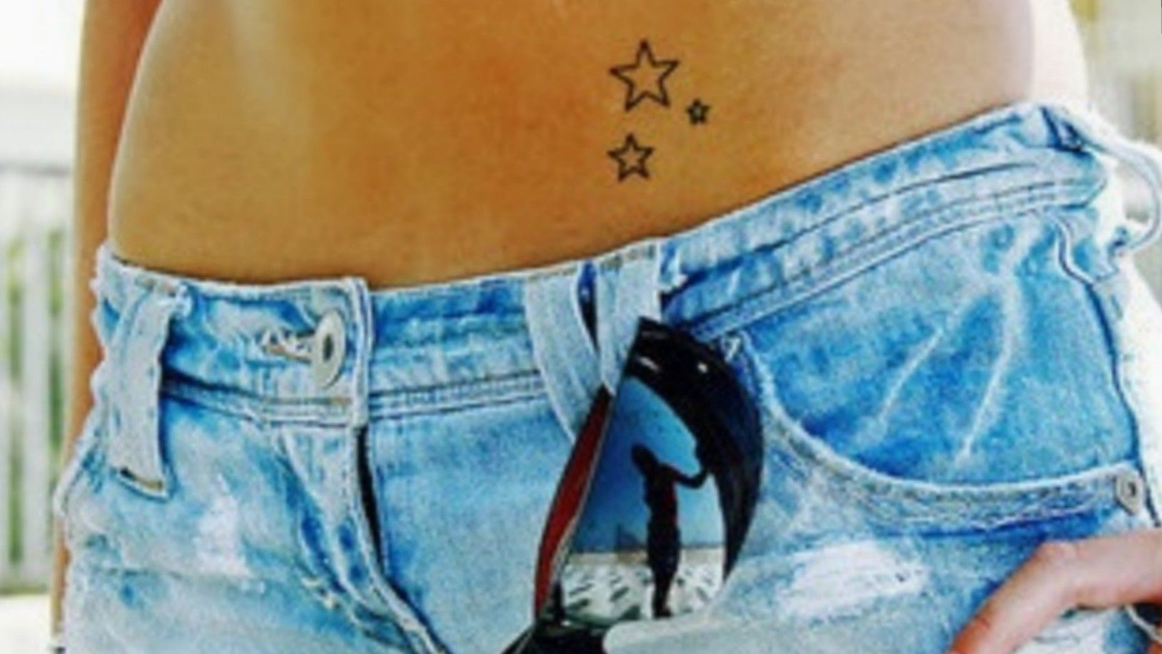Colorful hip star tattoo with swirls