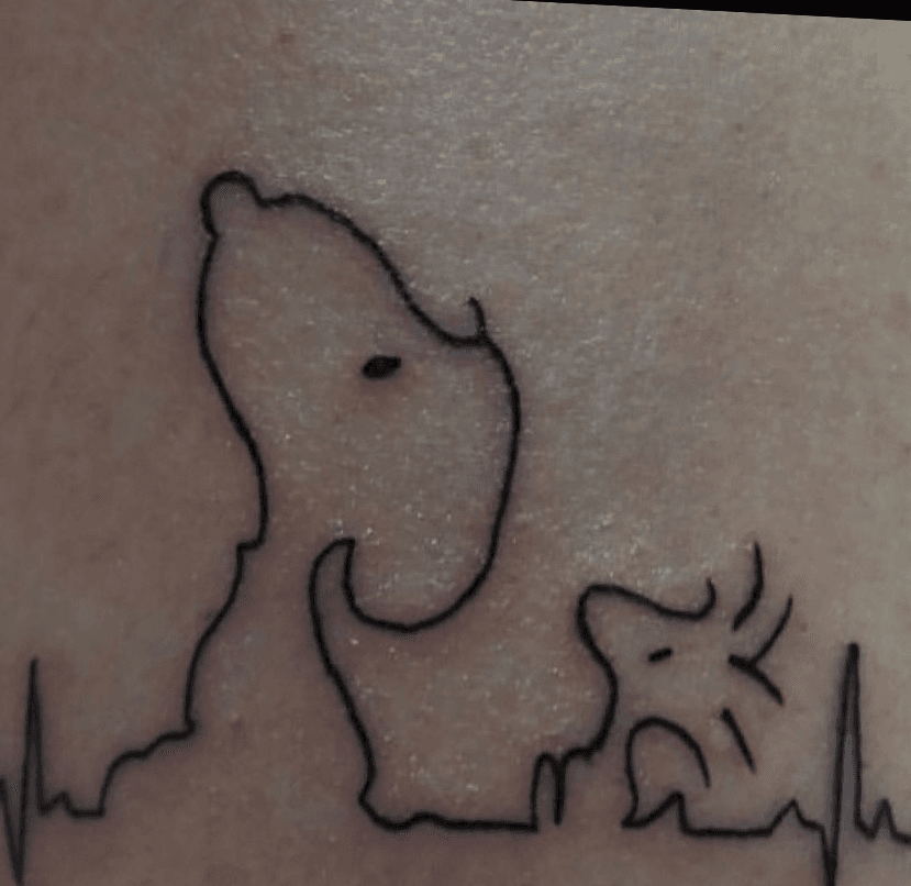 Minimalistic Snoopy tattoo located on the inner arm