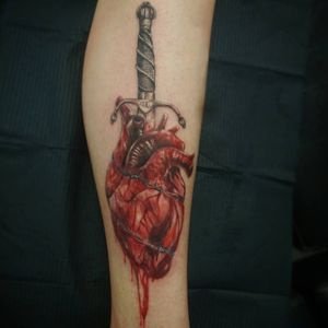Heart and dagger tattoo.