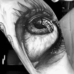 Realistic eye blackand grey realism portrait inner bicep tattoo sleeve filler