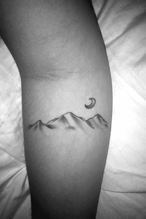 Black and white mountian range with crescent moon 