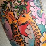 Traditional inspired giraffes, colorful clouds. 