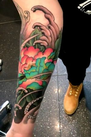 This is the underside of my forearm which has a Peony coloured in a classic japanese turquoise and pink. There are also waves on both sides of the forearm and some coloured leaves next to the Peony. 