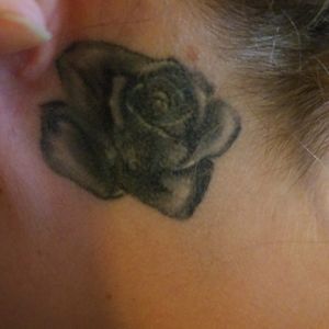 Rose cover up on neck behind left ear by Charline Marcila