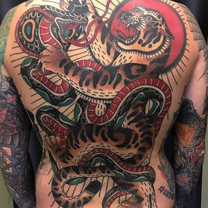 Tattoo by Adam Truarn #AdamTruarn #favoritetattoos #color #traditional #tiger #snake #reptile #animal #fight #nature #backpiece #backtattoo