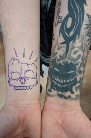 Matching *face* tattoos on wrists