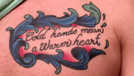 “Cold hands mean a warm heart.” My grandparents would say this to me every time they held my cold skinny hands. They would ask “are you dead?” Then they would follow up with that quote. So I got it tattooed on my chest in their memory. The frame was added on after I got the quote and the artist did an amazing job. I asked him for an ornate frame around the quote and to have the colors based on one of my favorite flowers, the blue bonnet. He then added little touches of baby blue and red to add contrast and make it pop. 