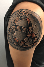 My first tattoo. I always loved the meaning behind the ouroboros. I also grew up on a farm in Cooper TX, sometimes would see a copperhead and I was always amazed at their beautiful color. I had my tattoo in the shape of a triquetra celtic knot to simbolize the Father, the Son, and the Holy Spirit. One of my favorite anime charactures is Orochimaru from Naruto and he has the power to summon a giant snake named Manda. This snake has four horn like protrusions on his head. I also wanted the horns to have a certain shape to them. So I based them on my favorite Disney villan, Maleficent. 