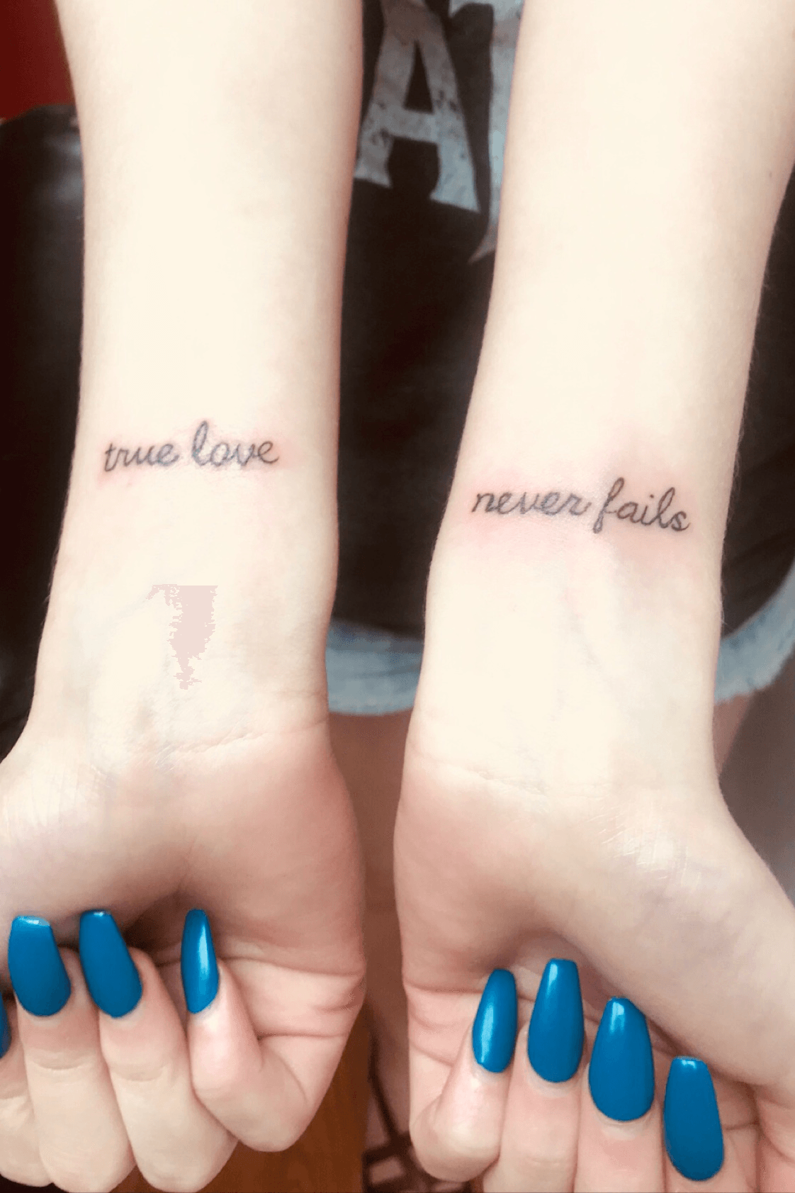 Love never fails tattoo on the inner forearm