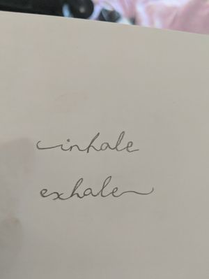 Just wrote this cute little font that says "inhale exhale". I really want to get this on my wrist or my ankle. I think it's super cute and can't wait to get it done.