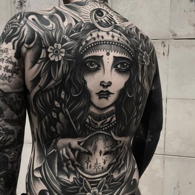 Tattoo by Rocky Darkroads #RockyDarkroads #darkarttattoos #blackwork #portrait #backpiece #backtattoo #crystalball #fortuneteller #gypsy #moon #stars #flowers #floral #magic #folklore #allseeingeye #eyes