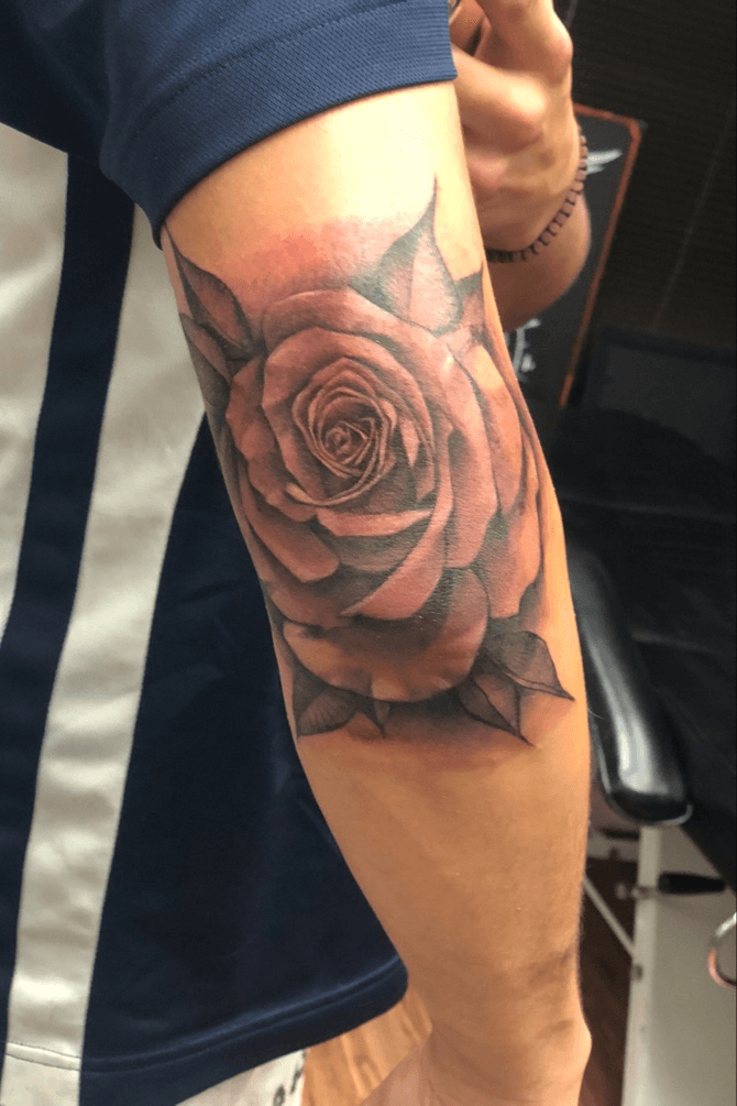 Traditional rose tattooed on the elbow by Dennis