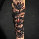 Tattoo by Alberto Escobar #AlbertoEscobar #clowntattoos #blackandgrey #redink #realism #realistic #hyperrealism #sadclown #tear #flower #lotus #clown #circus