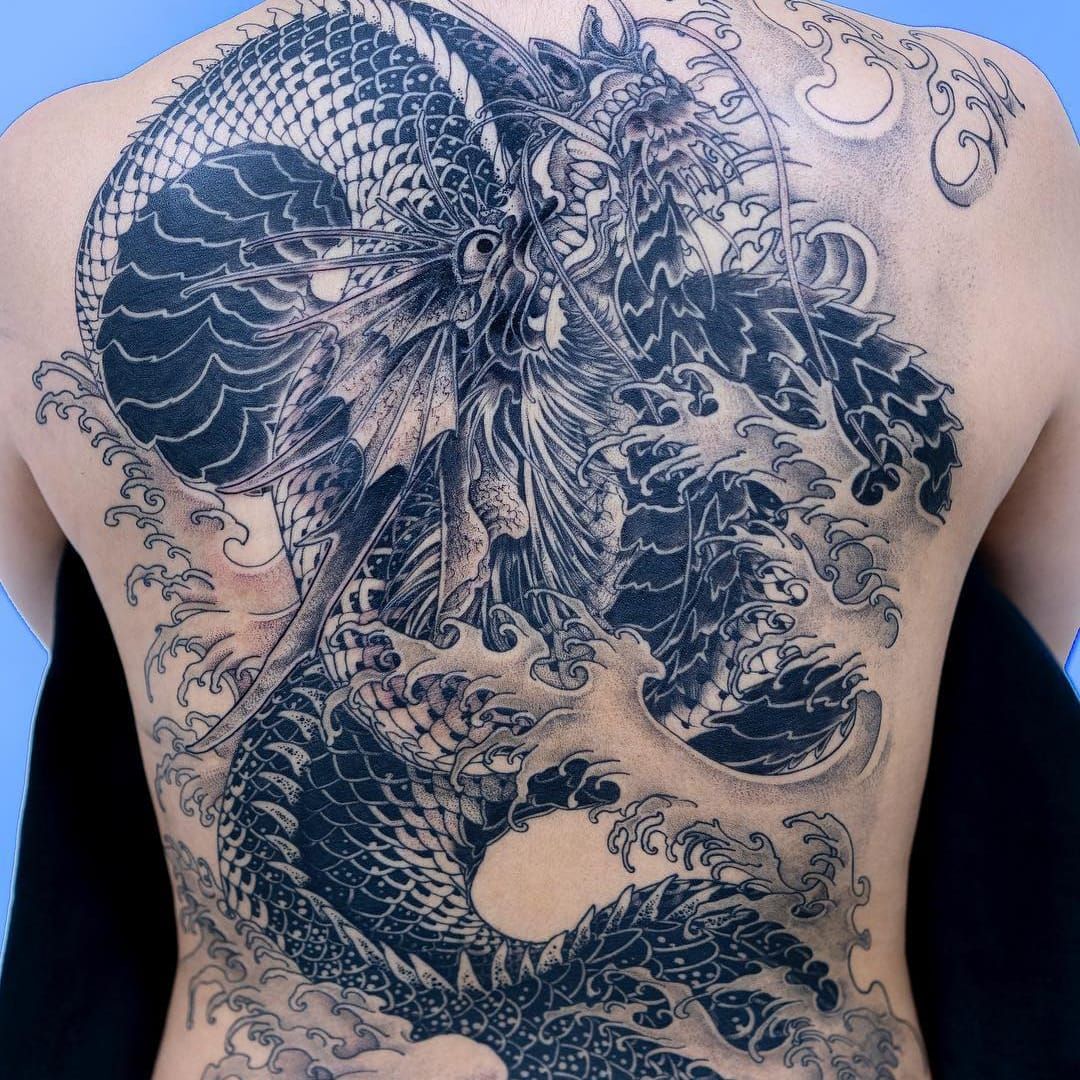 Tattoo uploaded by Tattoodo • Tattoo by Oozy #Oozy #dragontattoos  #blackandgrey #dragon #mythicalcreature #beast #monster #animal #waves  #Japanese #illustrative #backtattoo #backpiece • Tattoodo