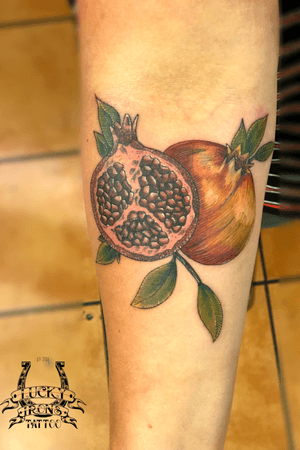 A cute pomegranate done by Gareth Doye. For bookings email info@luckyironstattoo.com or call us on 33 33 72 26. #tattoo #tattoos #tattoodo #ztattoo #pomegranate #colortattoo #armtattoo