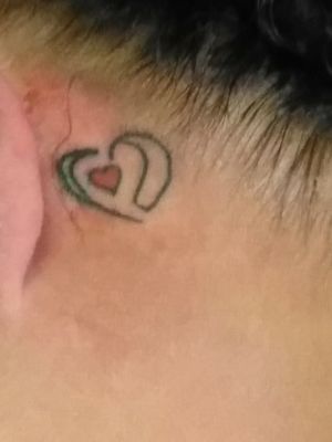 My mom 2nd tattoo.  It an cochlear implants with heart