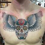 Sugar skull with wings chest piece and cover up. #traditionaltattoo #skulltattoo #chesttattoo 