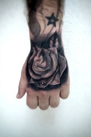 Rose tattoo on hand