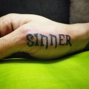 "Sinner" on the side of the client's right hand.