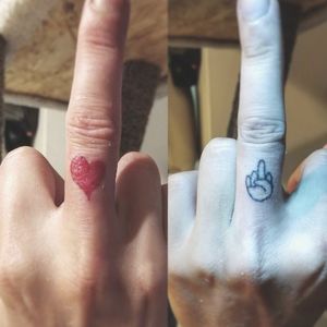 A small red heart and a tiny hand flipping the middle finger on the bottom knuckle of the client's middle fingers. "Fuck You with Love, or just Fuck You"