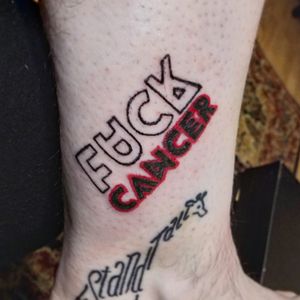 "Fuck Cancer" on the inside of the left leg near the ankle. Giraffe done by another artist.