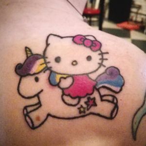 Hello Kitty riding a Unicorn on the client's back right shoulder