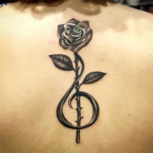 Absolutely love my first tattoo!!! It started out as a sketch I made and now I'm in LOVE with it!!! #tattooart #trebleclef #rose #artist #blackAndWhite #backtattoo #music #tattoo #realism 