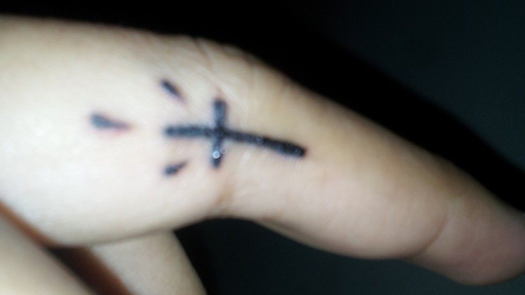 What does a cross tattoo between thumb and index finger signify  Quora