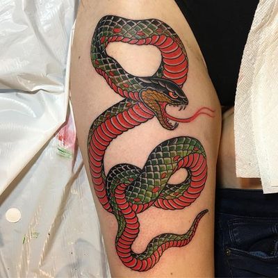 Experience the beauty and power of a Japanese snake tattoo on your thigh, expertly crafted by renowned artist Ami James.