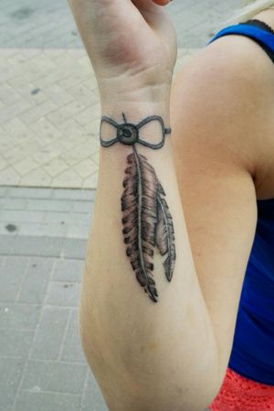 Bracelet and feathers tattoo... 