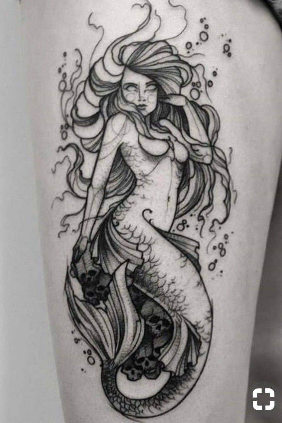 Watercolor mermaid tattoo on the thigh.