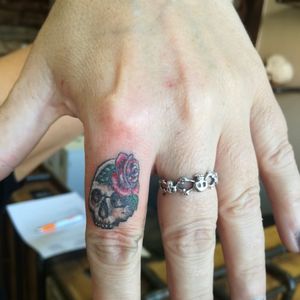Little skull finger tattoo