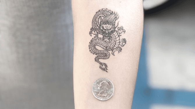 Fine line dragon tattoo on the forearm