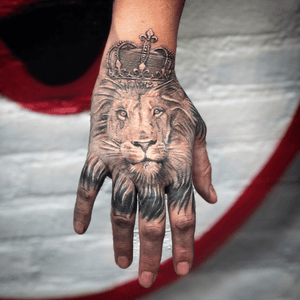 Lion hand tattoo black and grey on Bracha