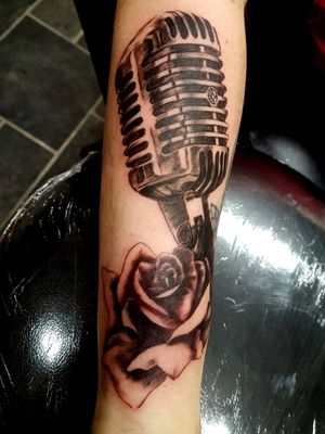 Microphone and rose. Theres an old tattoo under there somewhere 