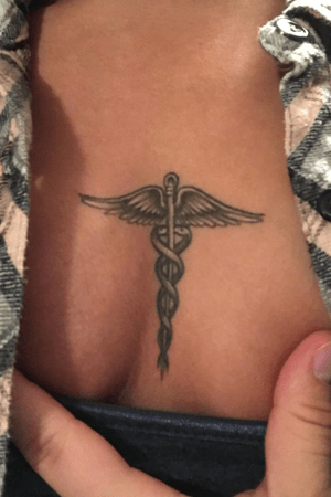 Caduceus on sternum. Done by Naldo at Buffalo Ink