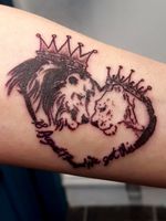 A small lion and lioness tattoo
