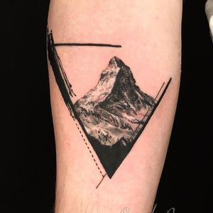 Embrace the beauty of nature with this blackwork landscape tattoo by artist Alex Santo. Perfect for those who love geometric designs.