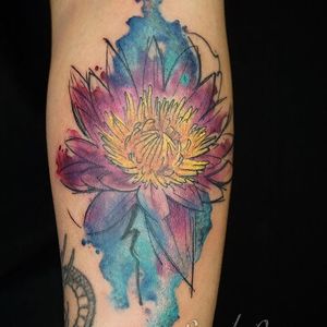 Vibrant watercolor lotus flower tattoo by Alex Santo, beautifully placed on lower leg for a stunning and unique look.