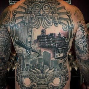 Tattoo by Chuey Quintanar #ChueyQuintanar #blackandPOCtattoos #POCtattoos #backpiece #architecture #bridge #sanfrancisco #alcatraz @california #cityscape #trolley #train #Mayan #aztec #stonework